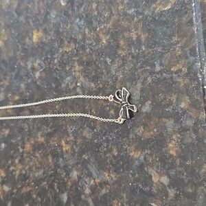 A dainty little bow necklace on a sixteen inch chain